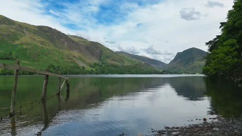 Still water mirrors distant hills and blue sky Stock Footage 345523268