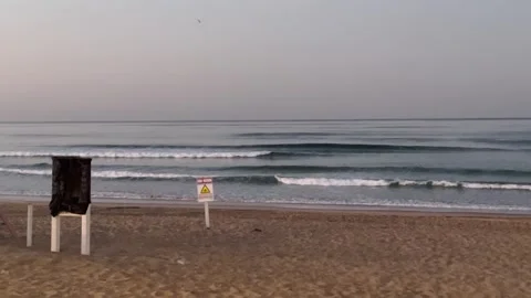 Stillness and Warning: A silent seaside where beauty meets caution Video stock 313049844
