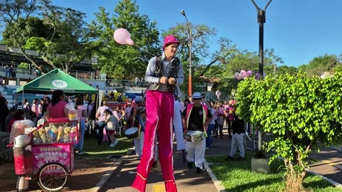 Stilt Performer Entertaining Attendees During Pink October Community Video stock 335908060