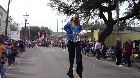 Stilt walker passes by during Mardi Gras Parade Stock Footage 52372984