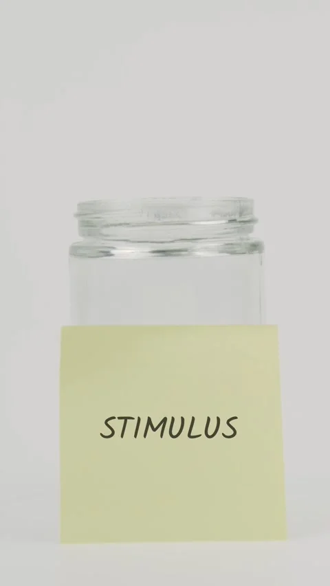 Stimulus text or word on yellow sticky note attached to glass jar with hand Stock Footage 311789738