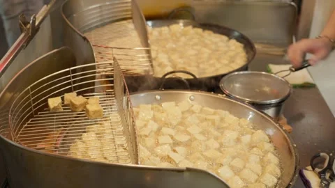 Stinky tofu is cooked and served at night street market, Taipei, Taiwan - 4k Stock Footage 295516235