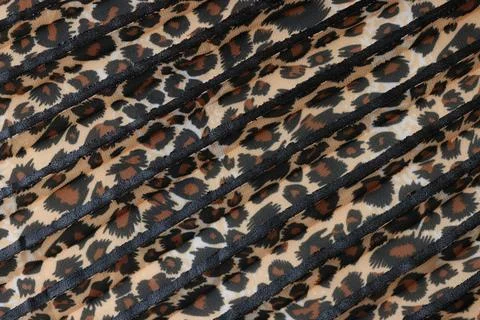 Stipes of fabric with leopard pattern close up. 스톡 사진