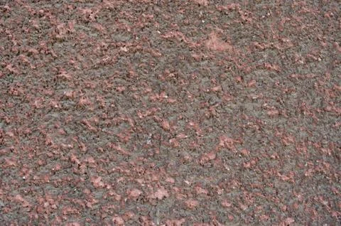 Stippled effect on plaster applied to a wall in dirty red Stock Photos