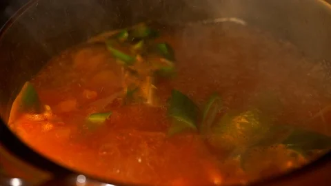 Stir the boiling soup. 库存影片 106656444