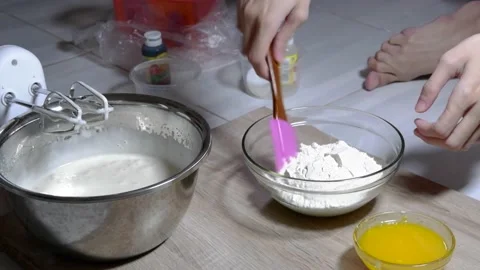 Stir the cake dough using a mixer in a metal bowl Stock Footage 236849752