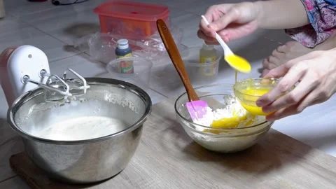 Stir the cake dough using a mixer in a metal bowl Stock Footage 236849782