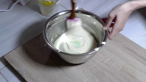 Stir the cake dough using a mixer in a metal bowl Stock Footage 236850045