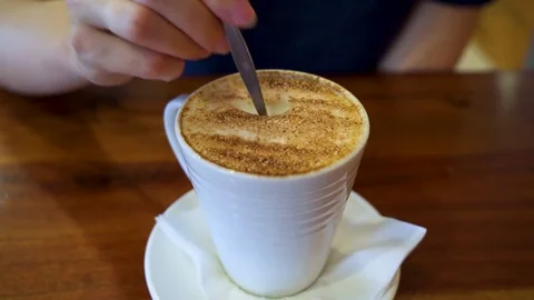 Stir capuccino in a white mug Stock Footage 81537368