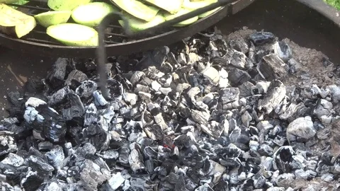 Stir coals under the grill grate. B-B-Q Stock Footage 109330678
