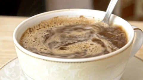 Stir coffee in the cup Stockbeeldmateriaal 115444580