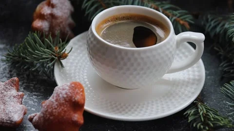 Stir coffee in a cup with a spoon. Hand holds a spoon and stirs hot espresso Stock Footage 224710282