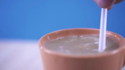 Stir coffee with a plastic spoon Stock Footage 134835048