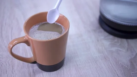 Stir coffee with a plastic spoon Stock Footage 134835095