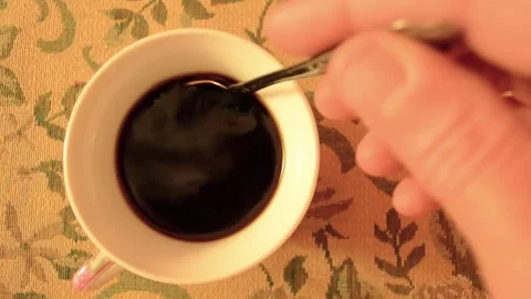 Stir the coffee with a spoon in a white Cup. Stock Footage 140972834