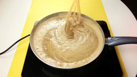 Stir custard in a pan Stock Footage 72507526