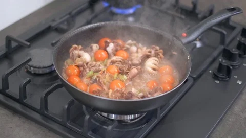 Stir fried baby octopus and vegetables in hot pan Stock Footage 113011253