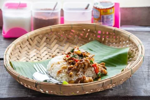 Stir fried basil leaf beef with rice and put Fried egg in Bamboo Basket on wo Stock Photos