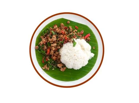 Stir fried basil leaf pork with rice and put the preserved egg on a white bac Stock Photos