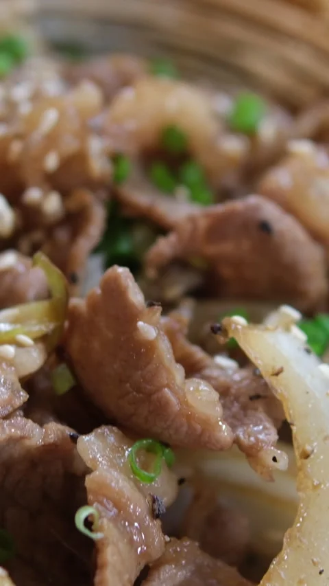 Stir-fried Beef and Rice Beef and broccoli served over rice on a plate overhead Stock Footage 310428115