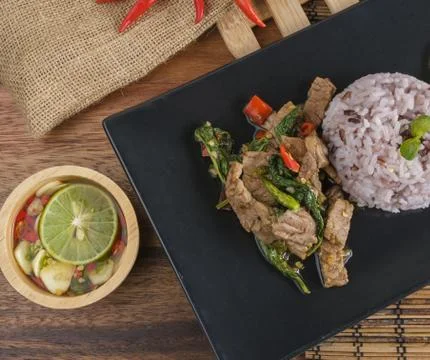 Stir-fried beef basil with fried egg and riceberry rice. Stock Photos