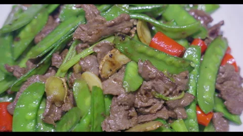 Stir-fried beef with snow peas, close-up, no people Stock Footage 329692719