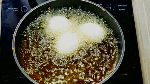 Stir-fried boiled egg with bubble food palm oil high temperature in induction Stock Footage 131180354