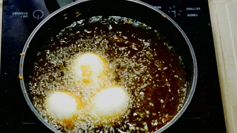 Stir-fried boiled egg with bubble food palm oil high temperature in induction Stock Footage 131180360