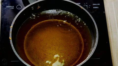 Stir-fried boiled egg with bubble food palm oil high temperature in induction Stock Footage 131180363