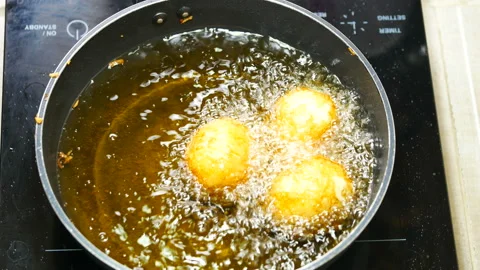 Stir-fried boiled egg with bubble food palm oil high temperature in induction Stock Footage 131180406