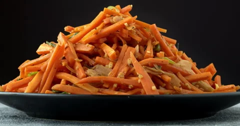 Stir-fried carrot with ginger. Table spin. Stock Footage 277514442