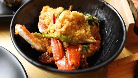 Stir-Fried Crab with Chili Paste in Black Bowl Close-Up Stock Footage 322556699