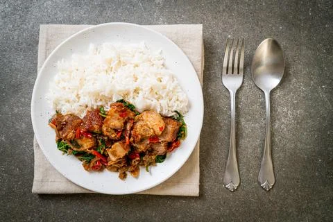 Stir-fried crispy pork belly and basil with rice Stock Photos
