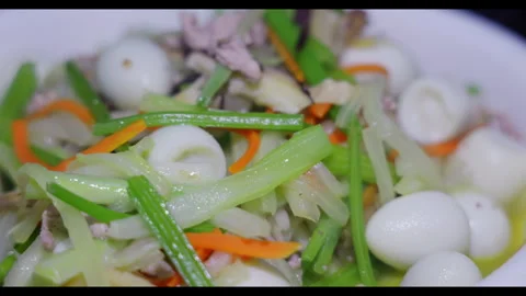 Stir-fried dish with quail eggs, vegetables, and meat, close-up, no people Stock Footage 329694225