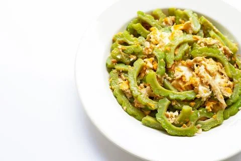 Stir-fried egg with bitter melon on a white dish on white Stock Photos