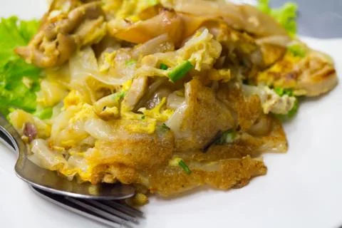Stir fried flat noodle and chicken and egg Thai street food Stock Photos