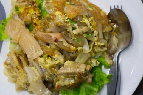 Stir fried flat noodle and chicken and egg Thai street food Stock Photos