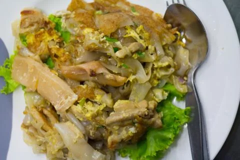 Stir fried flat noodle and chicken and egg Thai street food Stock Photos