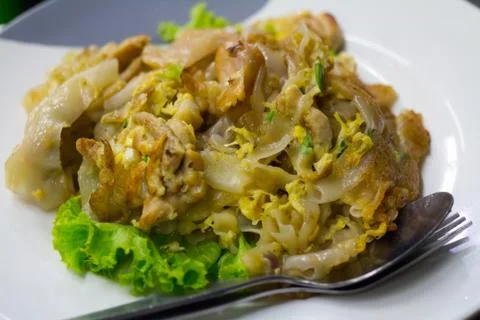 Stir fried flat noodle and chicken and egg Thai street food Stock Photos