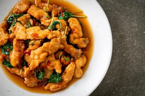 Stir-fried fried fish with basil and chili in thai style Stock Photos