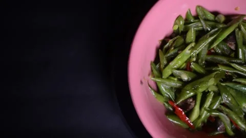Stir-fried green beans with liver served in a pink bowl Stock Footage 313983680