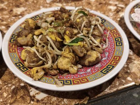 Stir fried radish cake with egg and bean sprouts on a plate Stock Photos