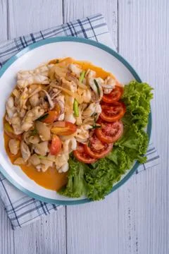 Stir-fried squid with salted egg yolk, onion, spring onion and Chili pepper o Stock Photos