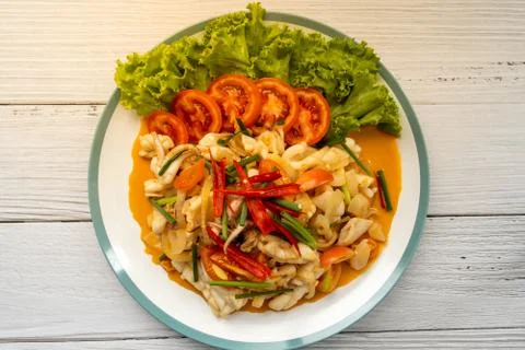 Stir-fried squid with salted egg yolk, onion, spring onion and Chili pepper o Stock Photos