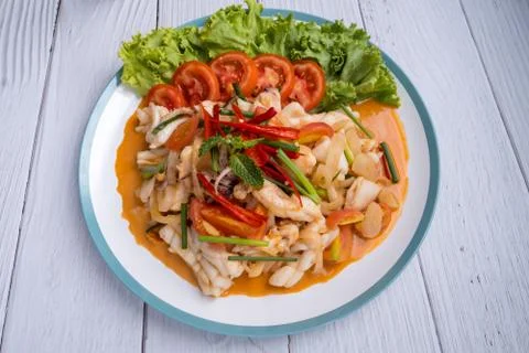 Stir-fried squid with salted egg yolk, onion, spring onion and Chili pepper o Stock Photos