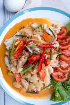Stir-fried squid with salted egg yolk, onion, spring onion and Chili pepper o Stock Photos