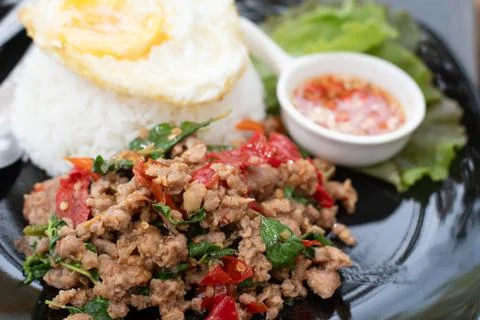 Stir fried Thai basil with minced pork and a fried egg. Stock Photos