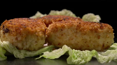 Stir-fried turkey cutlets on lettuce leaves on a black background. Stock Footage 154630401