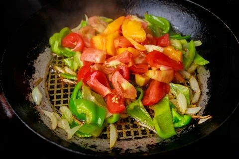 Stir-fried vegetables in iron skillet. Stock Photos
