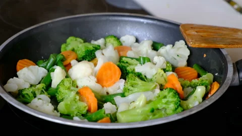 Stir fried vegetables in a wok on dark table, close up Stock Footage 97207682